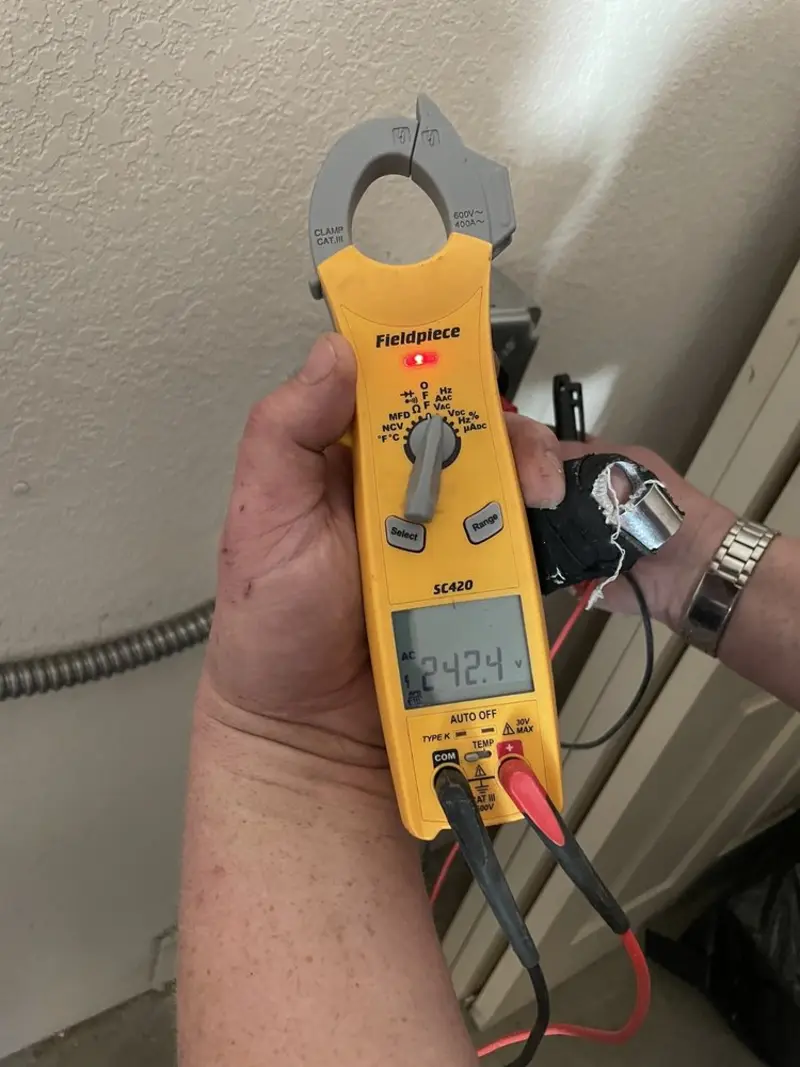 Voltage testing with clamp meter during Outlet Installation in North Tustin